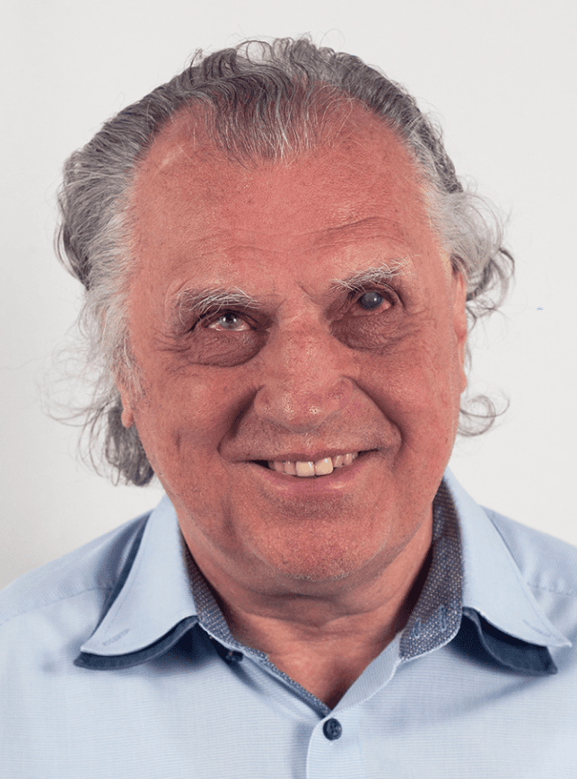 Portrait of Erich Schmid with grey hair and wearing a blue shirt